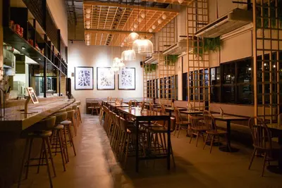 a restaurant with tables and chairs in a room at Lub d Manila Makati - Central Makati, Near Nightlife in Manila