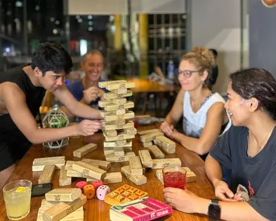 a group of people sitting around a table playing a board game at Lub d Manila Makati - Central Makati, Near Nightlife in Manila