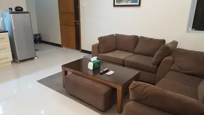 a living room with a couch and a coffee table at Morgan Suites in Manila