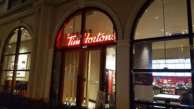 a store front with a neon sign in the window at Morgan Suites in Manila