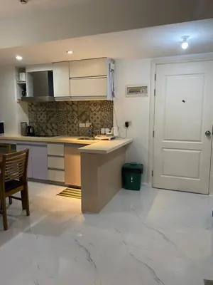 a kitchen with a counter and a white door at Azure Urban Resort and Residences by Rosary in Manila