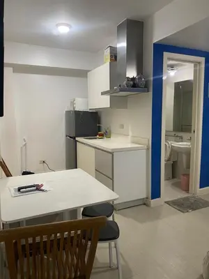 a small kitchen with a table and a counter top at Azure Urban Resort and Residences by Rosary in Manila