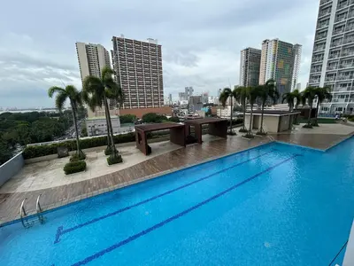 a large swimming pool on the roof of a building at Manila Bay Breeze Residences with Pool View in Manila