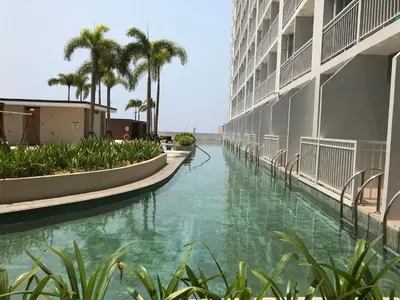 arial view of a canal in a building with palm trees at Manila Bay Breeze Residences with Pool View in Manila