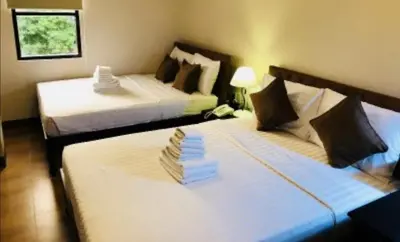 two beds in a hotel room with two beds at Achievers Airport Hotel in Manila