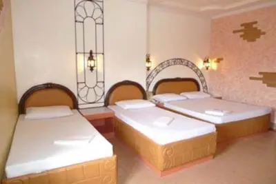 two beds in a room with two bedsitures at Urban Travellers Hotel in Manila