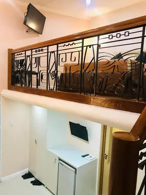 a staircase with a iron railing in a room at Urban Travellers Hotel in Manila