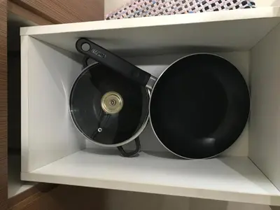 a black cd in a white shelf at One Palm Tree Apartments in Manila