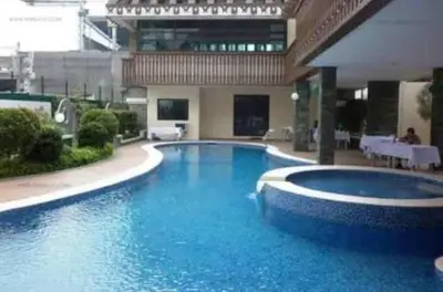 a large blue swimming pool in a building at Pine Crest Condominium in Manila