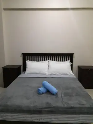 a blue object is laying on a bed at One Palm Tree Villas in Manila