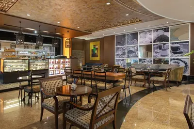a restaurant with tables and chairs and a bar at The Bellevue Manila in Manila