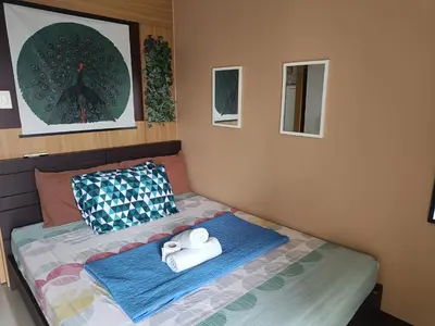a bedroom with a bed with towels on it at Shell Residences in Manila