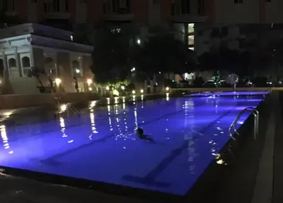 a person swimming in a pool at night at CHATEAU ELYSSE a4 near SM Mall,AIRPORT Wifi in Manila