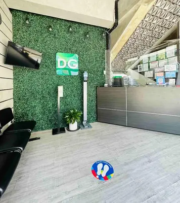 an office with a green wall with a dex sign on it at DG Budget Hotel Salem in Manila