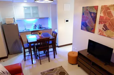 a kitchen and dining room with a table and chairs at Travellers 101 Condo near Manila Airport in Manila