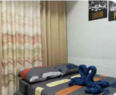 a bed with a suitcase and blue cords on it at Jazz Residences Condo in Manila