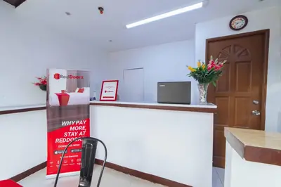 an office with a reception counter and a door at RedDoorz at San Antonio Binan Laguna in Biñan
