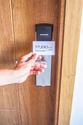 a persons hand unlocking a door with a card at Titan Condo at Studio City Tower 3 Alabang in Manila