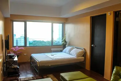a small room with a bed and a window at Titan 22P Condo at WH Taft Residences Manila in Manila
