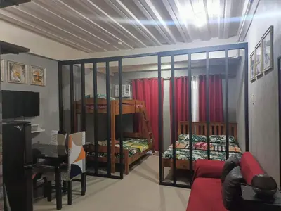 a room with two bunk beds and a couch at Vimelzu Mhavic Family Room in Manila