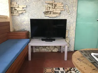 a tv sitting on a table in a room at 1 River Central Hostel in Manila