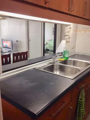 a kitchen counter with a sink and a mirror at 67 sqm. Condo Unit in Robinson Place Residences in Manila