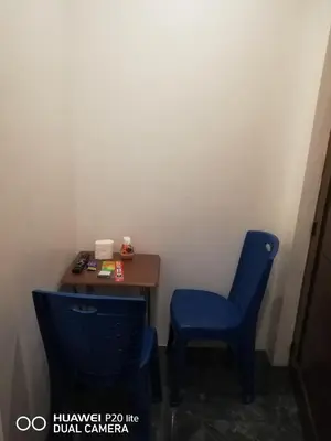 a desk and a blue chair in a room at Diaz Residence in Silang