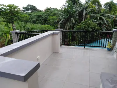 a balcony with a black fence and a tile floor at Diaz Residence in Silang
