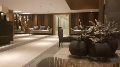 a living room with two large vases with plants in it at Azure Urban Resort Maui Unit in Manila