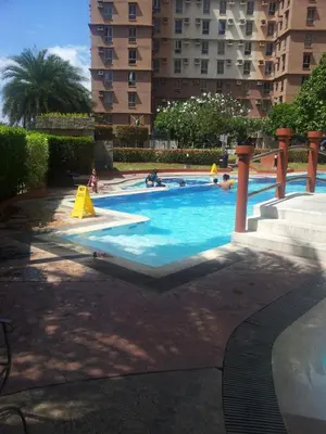 a swimming pool with people playing in the water at 2BR avida tower near NAIA airport in Manila