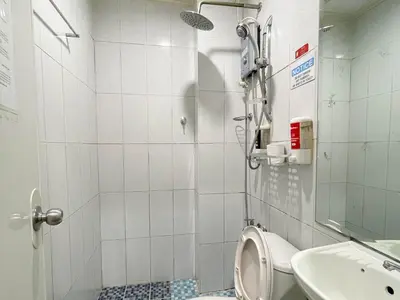 a small bathroom with a toilet and a sink at Chanel Paris Hotel powered by Cocotel in Manila