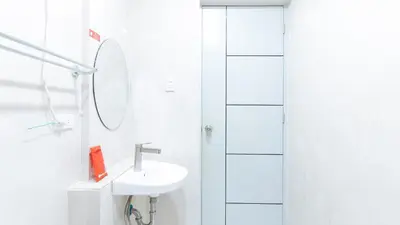 a white bathroom with a sink and a shower at RedDoorz near NAIA Terminal 1 in Manila