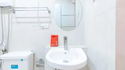 a white bathroom with a sink and a mirror at RedDoorz near NAIA Terminal 1 in Manila