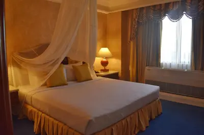 a hotel room with a bed with a canopy at Manila Prince Hotel in Manila