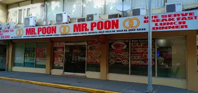 a fast food restaurant with a sign in front of it at Tropicana Suites in Manila