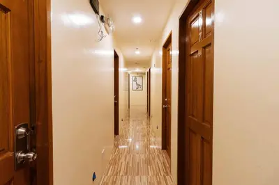 an empty hallway with a long floor of wood at RedDoorz at Hotel Rosemarie in Manila