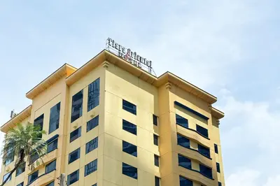 a building with a sign on top of it at Tiara Oriental Hotel Makati powered by Cocotel in Manila