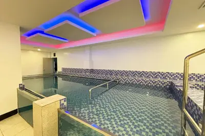 a large swimming pool in a large room at Tiara Oriental Hotel Makati powered by Cocotel in Manila