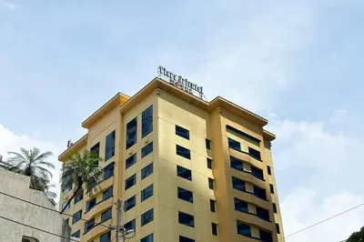 a yellow building with a sign on top of it at Tiara Oriental Hotel Makati powered by Cocotel in Manila