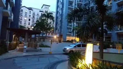 a car parked in a parking lot in a city at night at One Palm Tree Villas close to Manila Airport - Terminal 3 in Manila