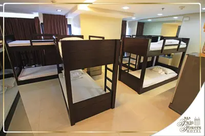 a group of bunk beds in a room with a mirror at BSA Twin Towers in Manila
