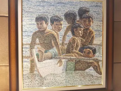 a painting of a group of children in a boat at Stay Amare Residences Malate in Manila