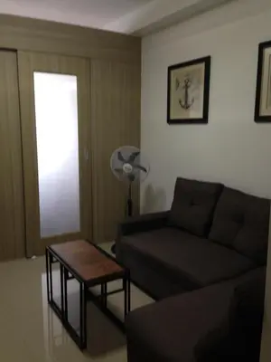 a living room with a couch and a table at Shore Residences MOA in Manila