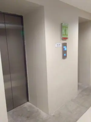 a elevator door in a building with a sign on the wall at Superb Edsa Cheap Hotel @ Graceysplace Unit 2 in Manila