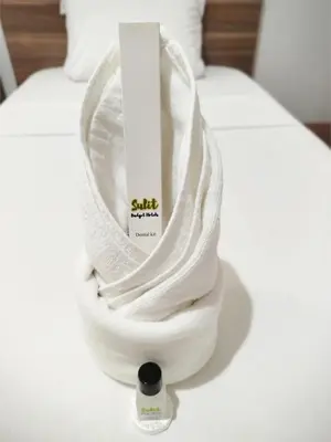 a white towel on top of a bed at Sulit Budget Hotel VMapa in Manila