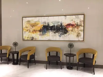 a waiting room with chairs and a painting on the wall at Eighty One Newport Boulevard in Manila