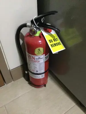 a red fire hydrant with a tag on it at Palm Tree Villas 2 in Manila