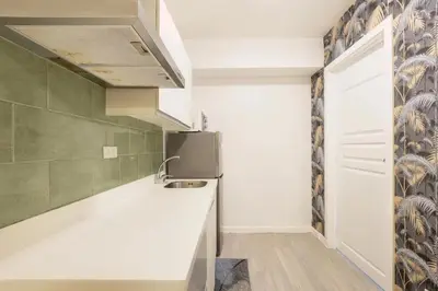 a kitchen with a sink and a refrigerator at Adam'sCrib Apartment 2BR by Azure Residences Near Manila International Airport in Manila