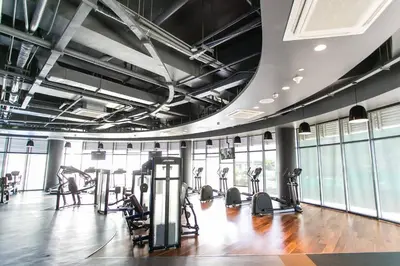 a gym with several treadmills and elliptical machines at Adam'sCrib Apartment 2BR by Azure Residences Near Manila International Airport in Manila