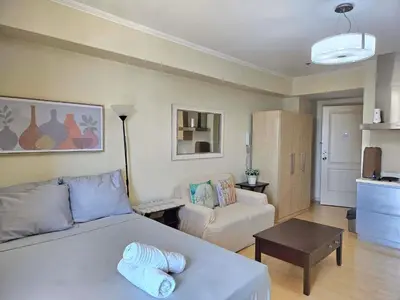 a living room with a bed and a couch at N place at Soho Central in Manila